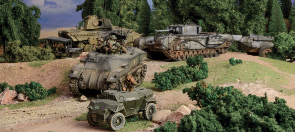 Bolt Action by Warlord Games - A Kangaroo APC and a Churchill Crocodile rumble past a brewed up Panther tank