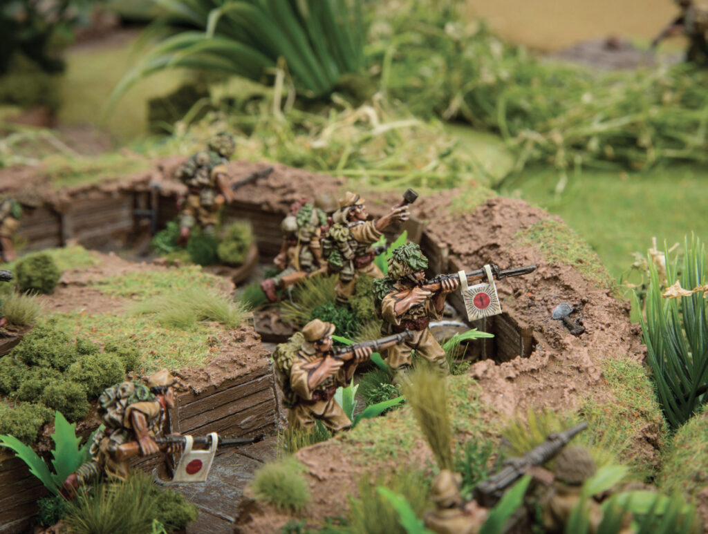 Japanese Bolt Action troops by Warlord Games man a trench