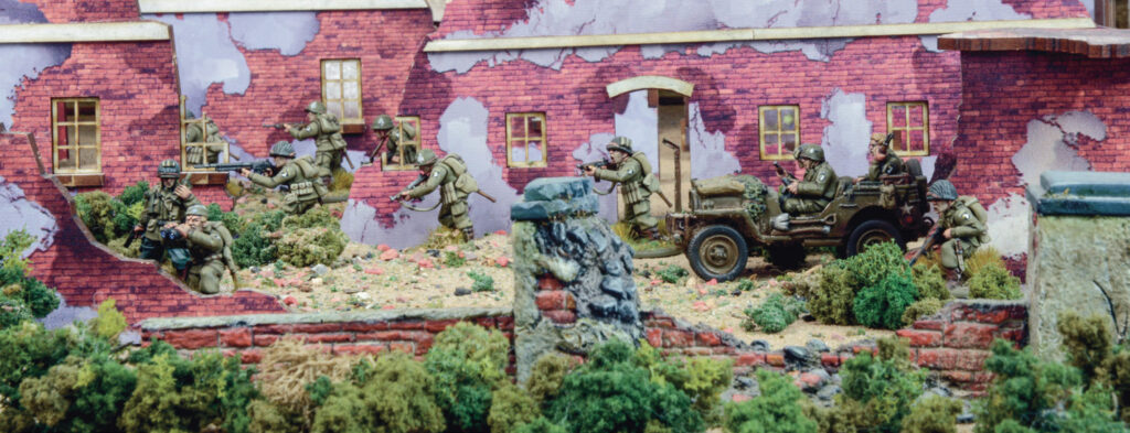 Bolt Action by Warlord Games, A US Airborne platoon moves through the ruins of a town in North-West Europe