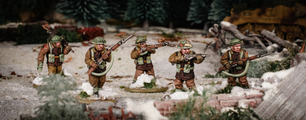 Winter British Infantry by Warlord Games advance into a ruined town.